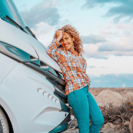 A couple outside their caravan with their dog watching the sunset protected by Moving Intelligence’s specially designed GPS tracking devices with insurance accreditation.
