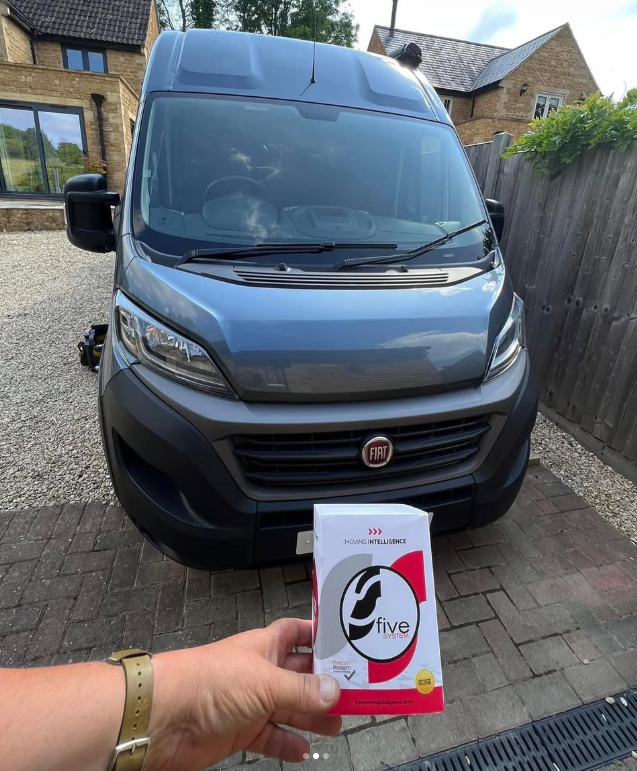 An S5 card held in front of a grey Fiat campervan on a driveway.