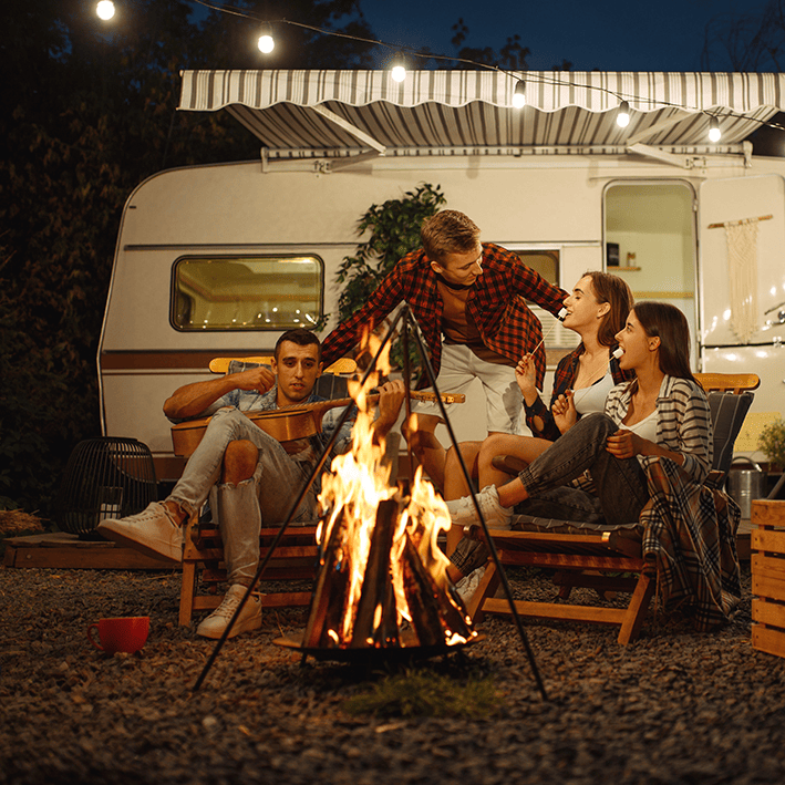 A woman sitting outside her motorhome watching the sunset able to enjoy the peace of mind that comes with Moving Intelligence’s highly rated service and insurance accredited devices specifically designed for motorhomes.
