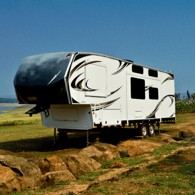 A large expensive caravan parked in the middle of a field protected by Moving Intelligence.