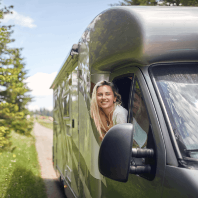 A couple sitting outside their motorhome on a hot sunny day enjoying the peace of mind that comes with Moving Intelligence’s state of the art technology.